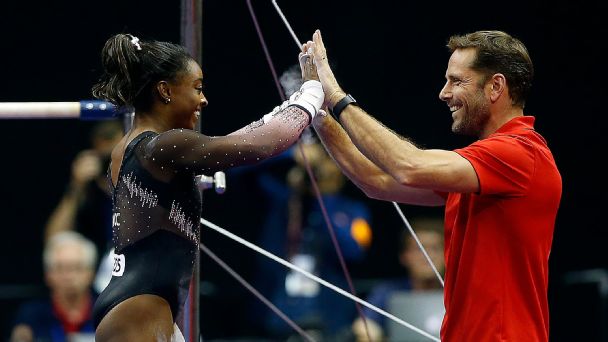 Biles with one of her coaches, Laurent Landi.