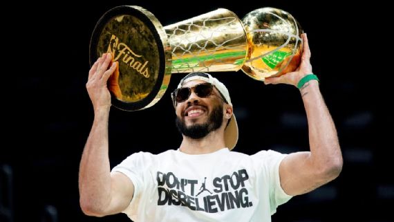 Jayson Tatum holding trophy