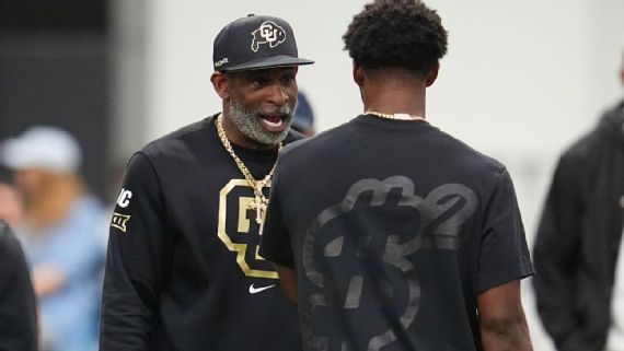 Deion Sanders ⁤speaks with⁢ his son,Shedeur,during ⁢an NFL⁢ Pro day showcase.