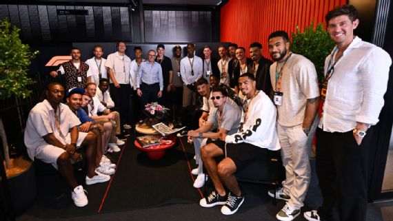 The England squad​ poses with Formula 1 CEO Stefano Domenicali ⁣at the ‍Spanish GP.