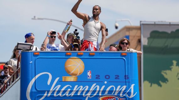 Shai Gilgeous-Alexander gestures to the crowd during the Thunder's championship parade.
