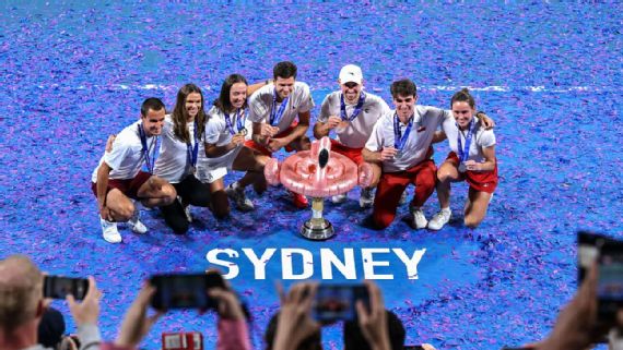 Poland's team celebrates with the winning trophy after defeating Switzerland in the final at the United Cup tennis tournament in Sydney.