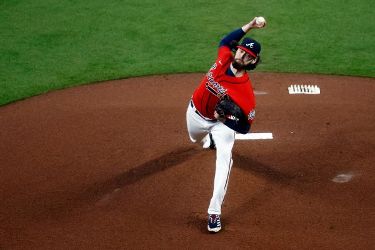 Atlanta Braves' Luke Jackson Cuddles Baby During World Series Game 3