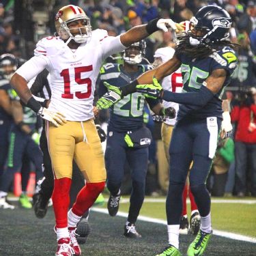 Seattle Seahawks running back Marshawn Lynch (24) dons his gloves during an  injury time out during the NFL Championship Game against the San Francisco  49ers at CenturyLink Field in Seattle, Washington on