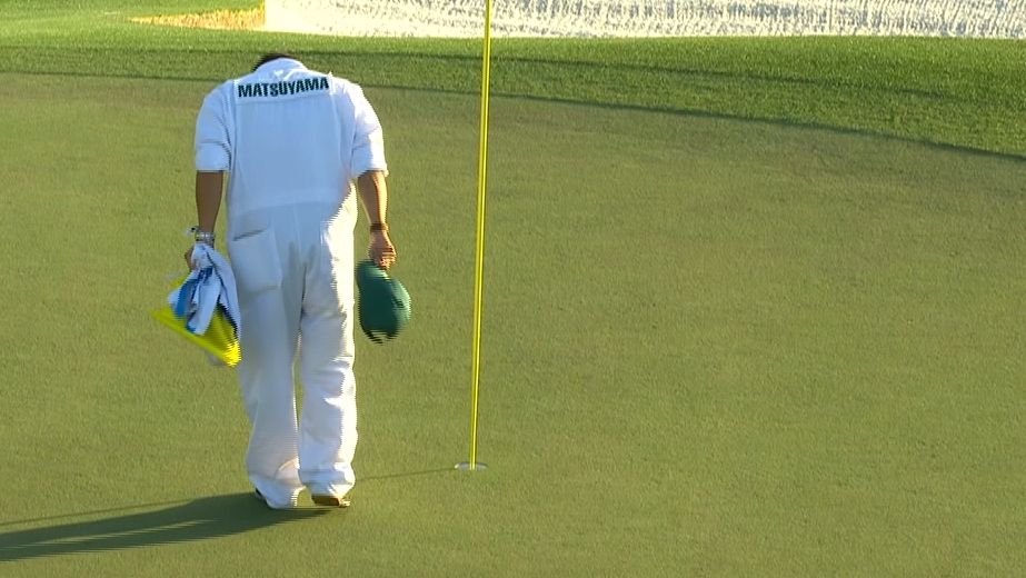 Matsuyama's caddie bows after placing the 18th hole pin ESPN Video