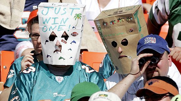 Miami Dolphins head coach Cam Cameron talks to Jason Taylor at Dolphin  Stadium in Miami on