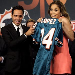 Marc Anthony and Stephen Ross hold a Miami Dolphins Jersey on the