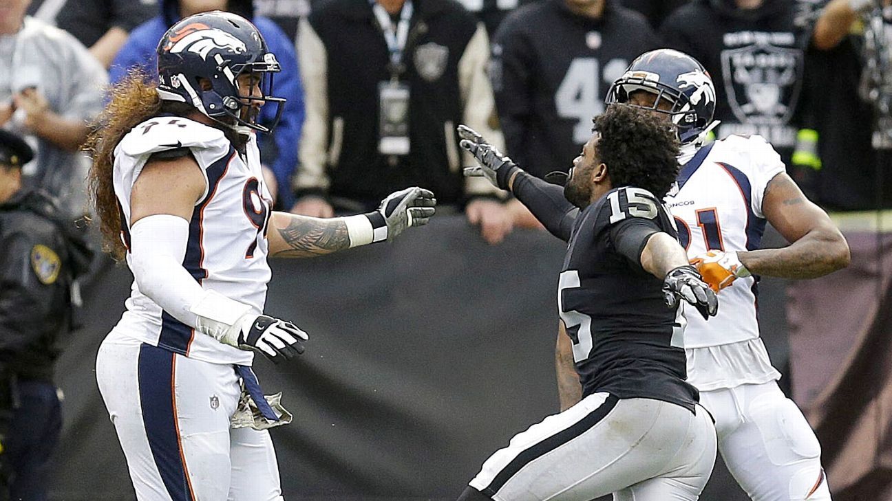 Michael Crabtree of the Oakland Raiders fights with Aqib Talib of