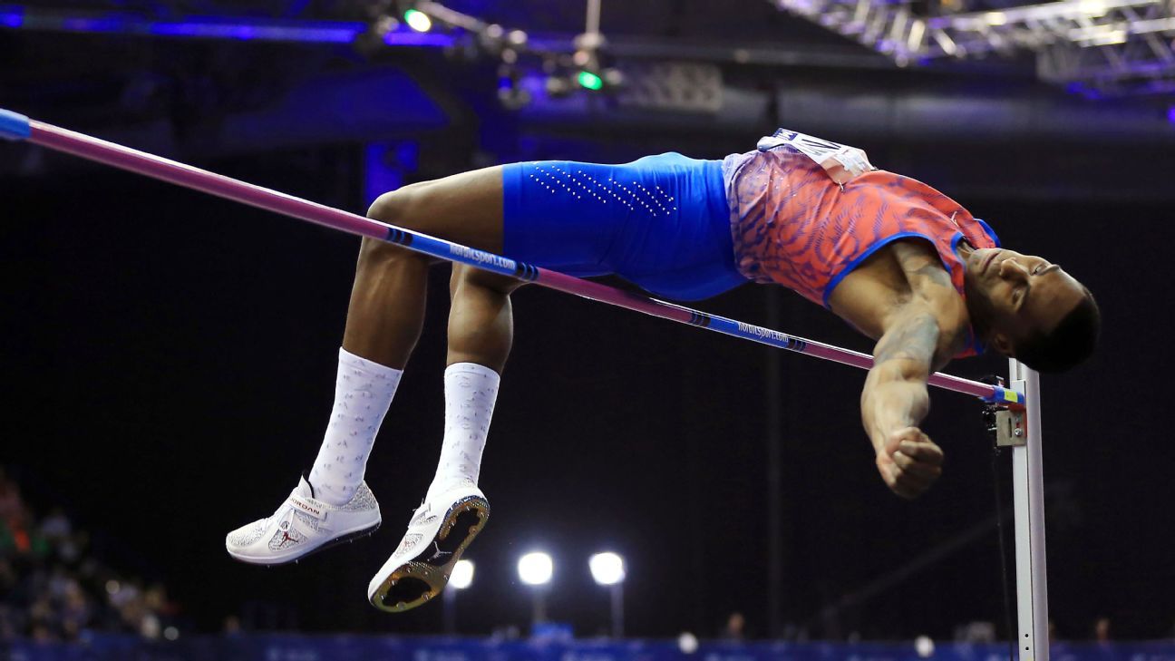 Skinny nerd athlete leaping in the long jump wearing vintage