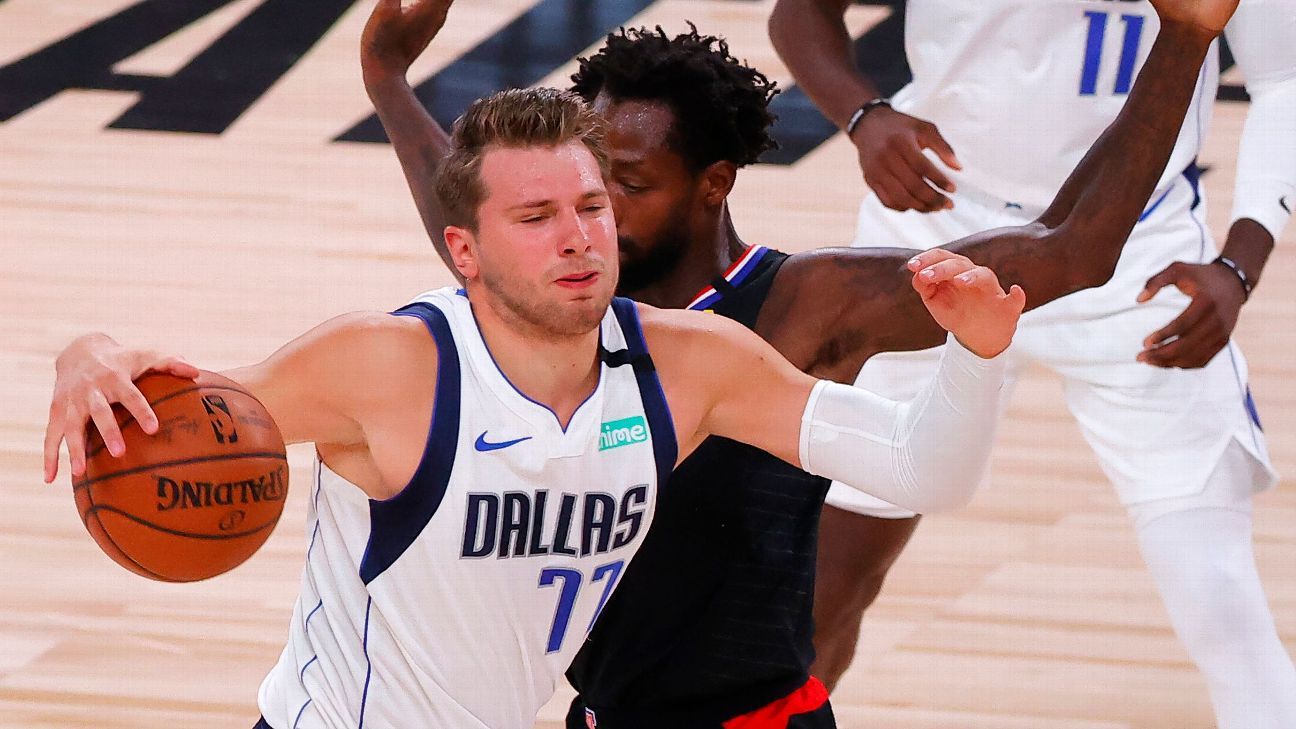 Dallas Mavericks forward Luka Doncic (77) pulls his jersey over his face  after missing a shot late in the second half of the team's NBA basketball  game against the Oklahoma City Thunder