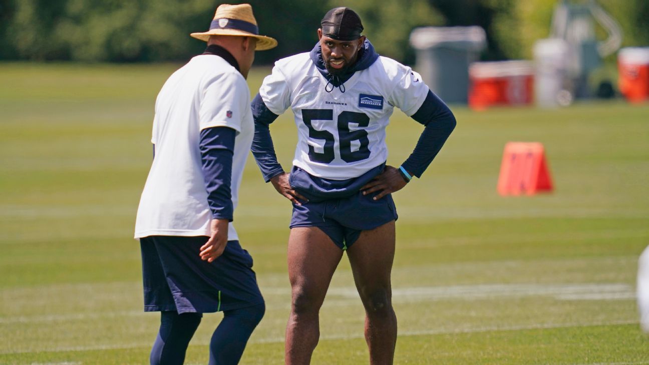 Seattle Seahawks linebacker Jordyn Brooks (56) tosses a signed ball back to  a fan during the NFL football team's training camp, Thursday, Aug. 3, 2023,  in Renton, Wash. (AP Photo/Lindsey Wasson Stock