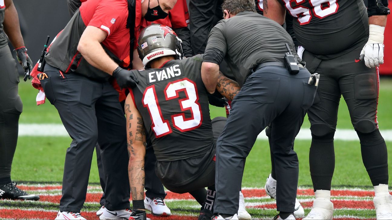 Mike Evans of the Tampa Bay Buccaneers injures his knee after a record