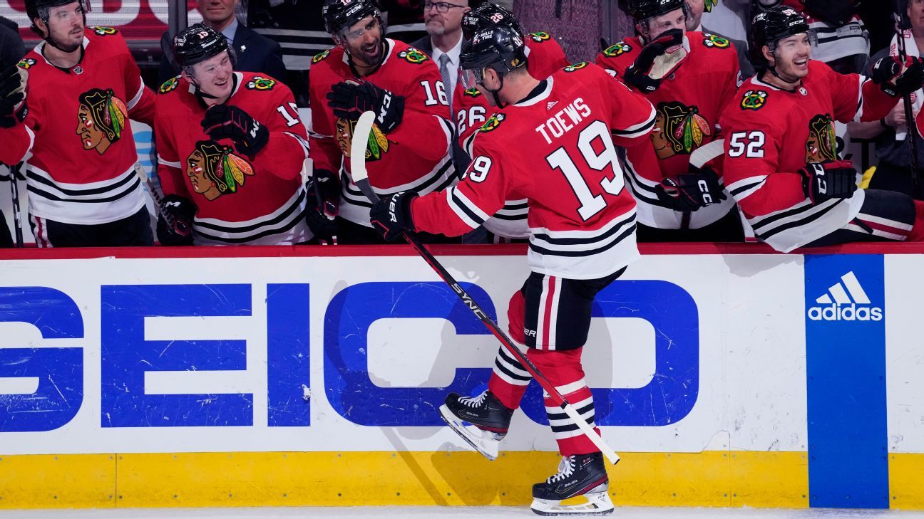 Chicago Blackhawks NHL hockey team general manager Kyle Davidson, left, and  new head coach Luke Richardson hold up a jersey during a news conference in  Chicago, Wednesday, June 29, 2022. Richardson becomes