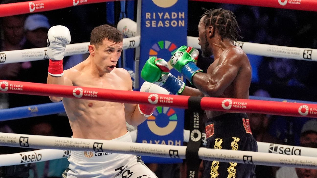 Crawford ekes out decision, now 4-weight champ