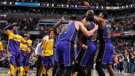LeBron James celebrates with teammates after scoring the winning shot.