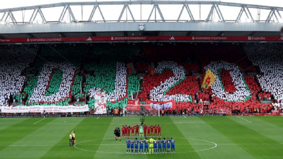Liverpool fans holding 'DJ20' and 'AS30' banners during tribute for Diogo Jota and André Silva